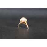 An 18ct yellow gold pearl set ring, the pear approximately 8mm in diameter, size N, approximately 2.