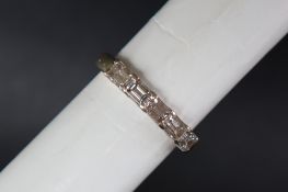 An 18ct gold five stone diamond ring set with baguette cut diamonds to a white metal setting and