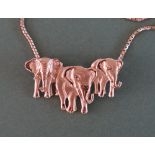 A 14ct yellow gold pendant in the form of three elephants approximately 7.