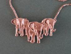 A 14ct yellow gold pendant in the form of three elephants approximately 7.