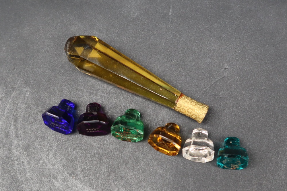 A 19th century cased set of six intaglio coloured-glass seals, with a faceted amber glass handle, - Image 4 of 5