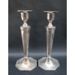 A pair of George V silver candlesticks,