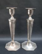 A pair of George V silver candlesticks,