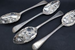 A set of four Victorian silver bead pattern berry spoons, the bowls decorated with fruit and leaves,