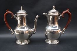 A George V silver coffee pot of baluster form on a spreading foot,