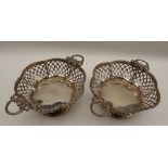A pair of George V silver twin handled pedestal dishes lobed pierced form on a spreading foot,