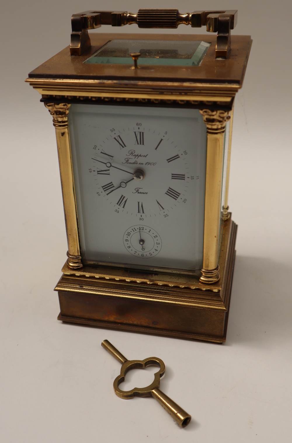 A 20th century brass cased carriage clock, with a circular dial with Roman numerals and alarm dial, - Image 7 of 7