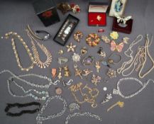 A pearl necklace together with assorted costume jewellery including brooches, wristwatches,