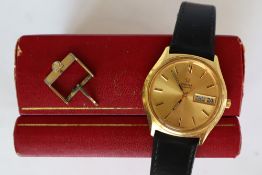 A gentleman's Omega gold plated quartz day date wristwatch with a gilt dial and batons on a leather