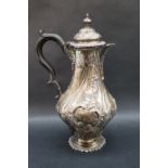 A late Victorian silver coffee pot of baluster form with embossed decoration of flowers,