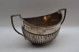 A George V silver twin handled sugar basin, with a half gadrooned body, Sheffield, 1924,