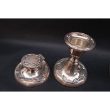 An Edward VII silver desk inkwell and matching candlestick, with raised scrolling decoration,
