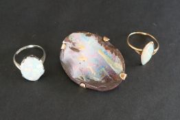 An opal ring of pointed oval form to a yellow metal setting and shank,