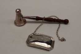 An Elizabeth II silver candle snuffer of pointed domed form with a turned handle,