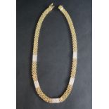 An 18ct yellow gold brick pattern diamond set necklace,