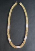 An 18ct yellow gold brick pattern diamond set necklace,