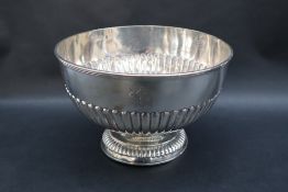 A late Victorian silver pedestal bowl of circular form with a half gadrooned body on a spreading