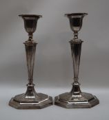 A pair of Edward VII silver candlestick, of octagonal tapering form, on a spreading foot, Sheffield,