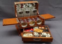 An oak cased and brass bound tantalus / games compendium, comprising three decanters,