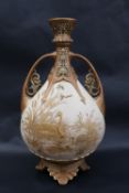 A Royal Worcester twin handled vase with a reticulated flared top above a tear drop shaped body