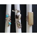 A collection of five silver rings, set with semi precious stones, including turquoise,