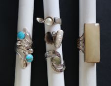 A collection of five silver rings, set with semi precious stones, including turquoise,