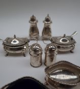 A pair of George V silver mustard pots and covers together with a matching pair of pepperettes,