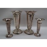 A pair of George V silver bud vases with a flared top above a tapering body and spreading foot,