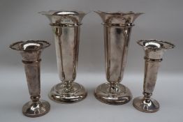 A pair of George V silver bud vases with a flared top above a tapering body and spreading foot,