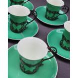 A set of six George V Aynsley coffee cups and saucers in silver slip mounts, London,