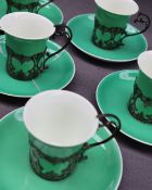 A set of six George V Aynsley coffee cups and saucers in silver slip mounts, London,