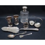 A silver napkin ring together with a silver spoon, continental white metal topped scent bottle,