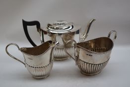 A George V silver three piece teaset, of oval form with a half gadrooned body, Sheffield, 1923,