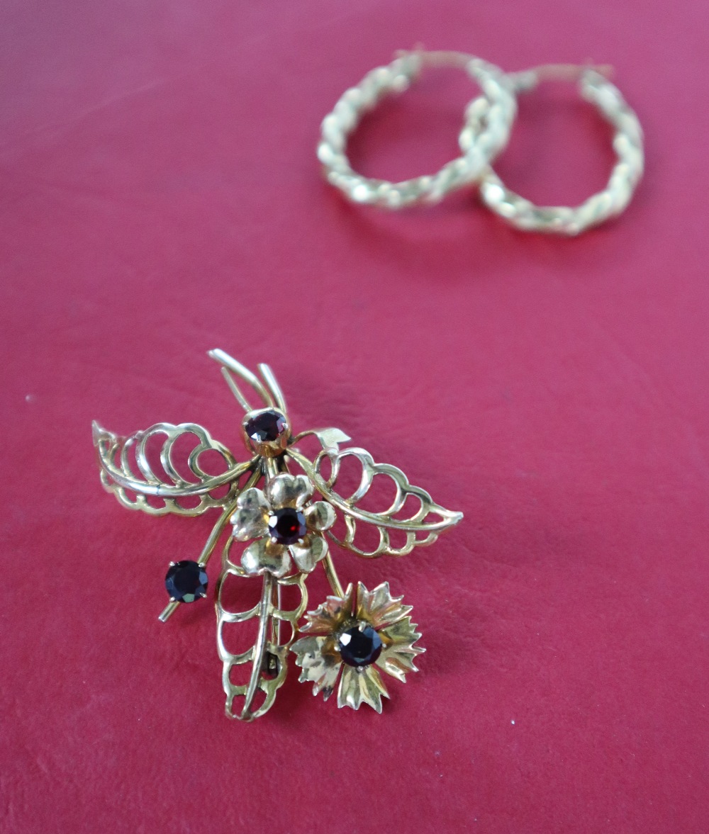 A 9ct yellow gold brooch of floral form set with garnets together with a pair of 9ct gold hoop