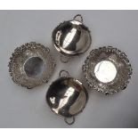 A pair of late Victorian silver bon bon dishes of circular form decorated with fruit and leaves,