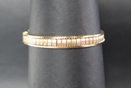 A 9ct three tone gold bracelet, 19.5cm long, approximately 20.