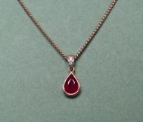 An 18ct gold ruby and diamond pendant,