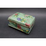 A Japanese cloisonne enamel box and cover of rectangular form decorated with flowers and leaves to