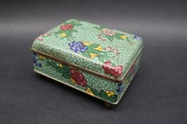 A Japanese cloisonne enamel box and cover of rectangular form decorated with flowers and leaves to