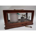 A mahogany cased Barograph with a carrying handle and four glass sides with a brass barrel and base