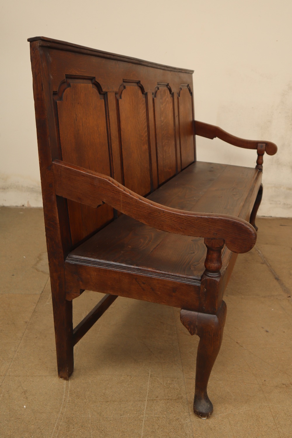 An 18th century oak settle with a four panel back and solid seat on cabriole legs and pointed pad - Image 3 of 6