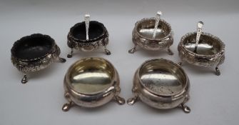 A pair of Victorian silver cauldron salts decorated with leaves and flowers on three legs, Exeter,