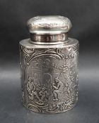 A continental silver tea canister with a domed cover above a cylindrical body embossed with figures