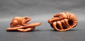 A netsuke in the form of a toad on a leaf,