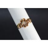 An 18ct gold ring set with an old cut diamond to a floral setting, size M 1/2, approximately 3.