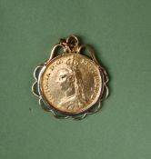A Victorian gold double sovereign dated 1887 in a yellow metal mount,