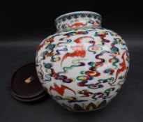A Chinese polychrome porcelain vase painted with bats in flight amongst clouds,