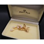 A 9ct yellow gold brooch set with six pearls as a floral spray approximately 5.