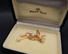 A 9ct yellow gold brooch set with six pearls as a floral spray approximately 5.