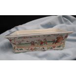 A Chinese porcelain planter of rectangular form with vignettes depicting children playing and